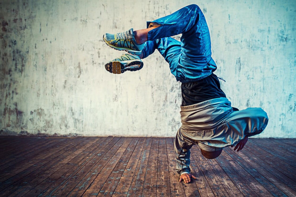 Young man dancing by doing flip in the air