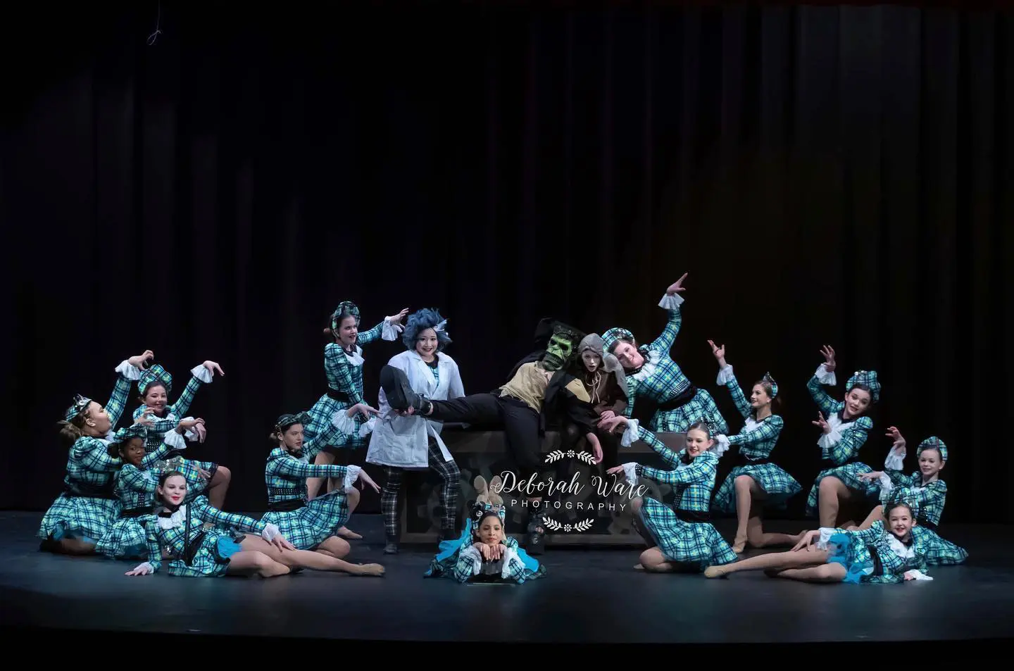 Group of Dancers in Teal Checks Dancing on the Stage