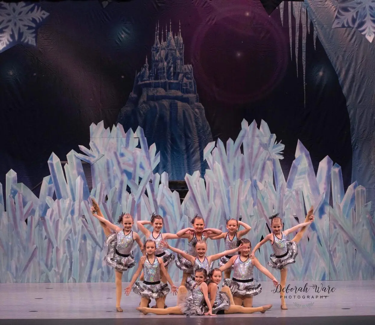 A Group of Girls in Shiny Ballerina Costumes on a Stage