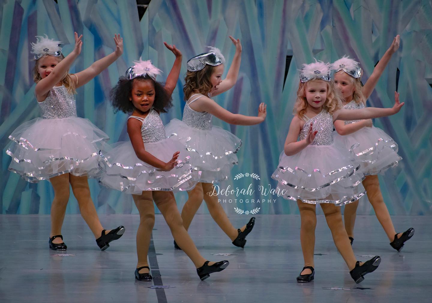 A Group of Girls in White Frocks Dancing on Stage