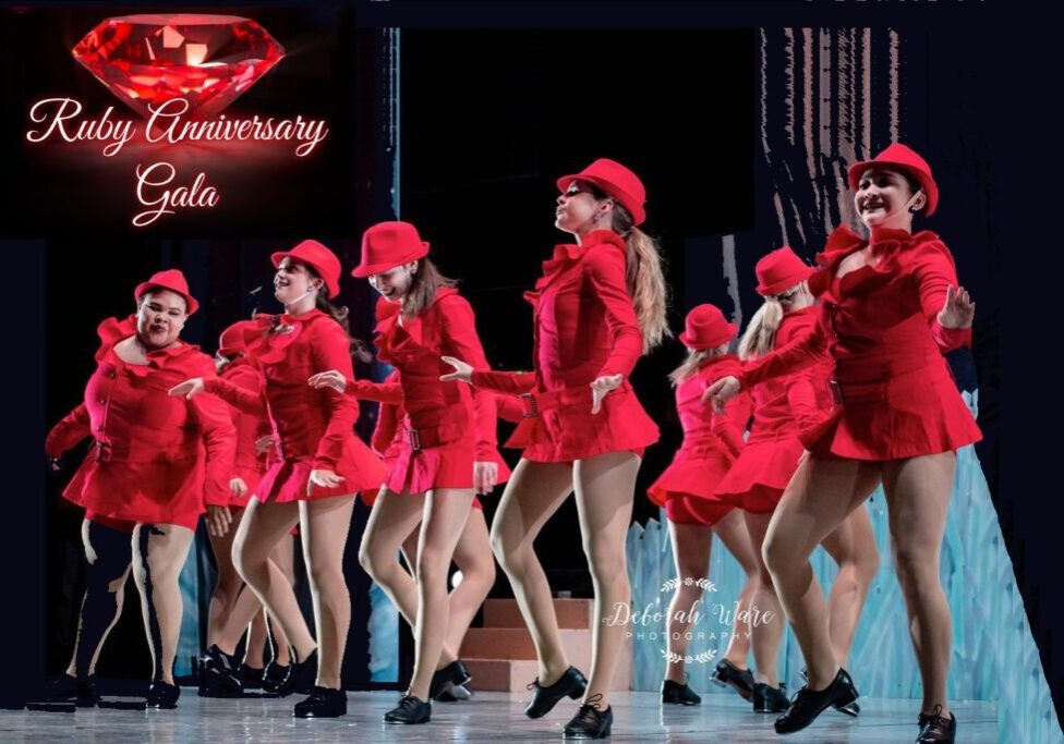 A group of women in red outfits and black shoes.